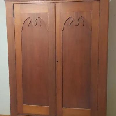 Antique Solid Wood Armoire with Ornate Cutout Panels
