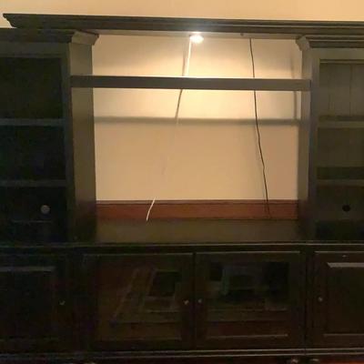 Large Black Entertainment Center with Brown Tones & Storage Cabinets
