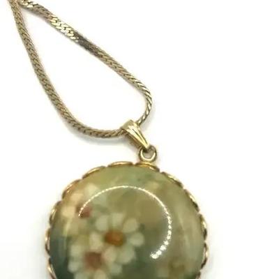 Gold-Tone Necklace With A Round Floral Pendant.
