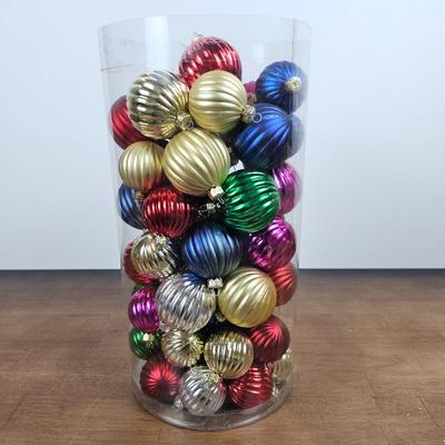Lot #68 - Large Tube of Multi-Color Ribbed Ball Ornaments – Red, Gold, Green, Blue & Silver Mix