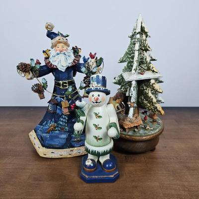 Lot #86 - Set of Christmas Figurines – Blue Santa, Snowman, and Musical Holiday Tree Scene