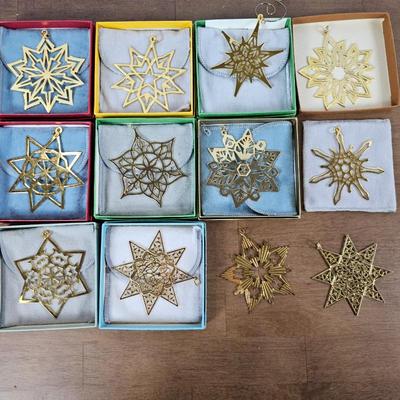 Lot #17 - Annual Metropolitan Museum of Art Gold Star Ornaments from the 1970s & 1980s. 12 total. 