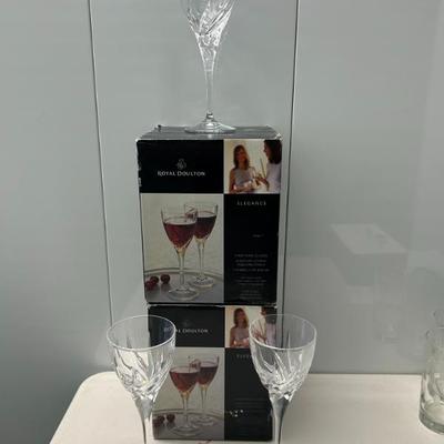 Sale Photo Thumbnail #345: Royal Doulton crystal wine stems. 2 sets of 4 in the box and one set of 3 out of the box. 11 total available. 
