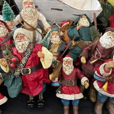 Lot 110:  Vintage Santa Figurine Collection with Rustic Sleigh and Holiday Décor
