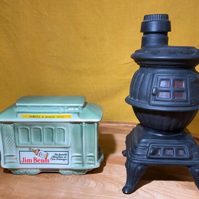 A pair of collectible ceramic whiskey decanters: Jim Beam trolley and Ezra Brooks stove