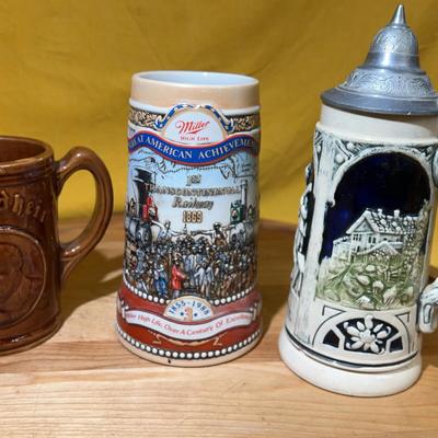 Collection: “Gesundheit” stein, commemorative Miller High Life, andGerman beer stein with pewter lid