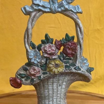 A vintage cast iron "French Basket" flower doorstop by Hubley