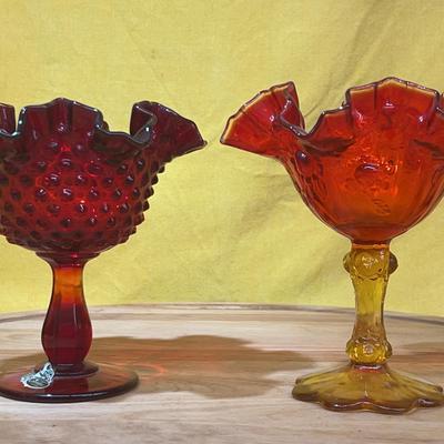 Two Fenton hobnail glass compote dishes, one red and one Amberina