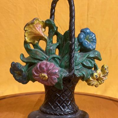 Vintage cast iron doorstop with a floral bouquet in a basket