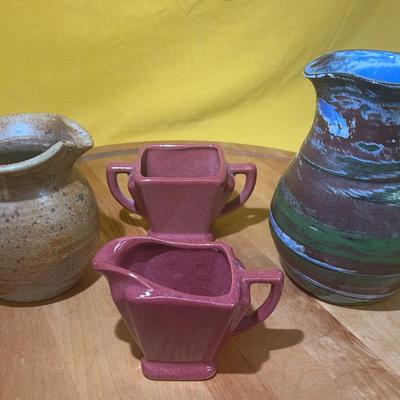 Collection of studio pottery pitchers and creamer cups
