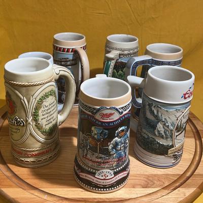 Collection of ceramic beer steins from various breweries