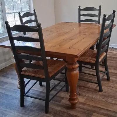 Rustic Wooden Dining Table with Four Wicker-Seat Chairs