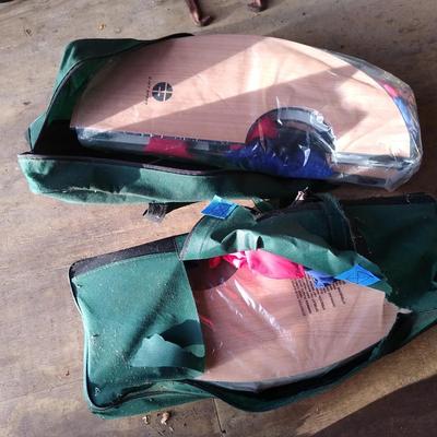 Two cases with corn hole lawn games