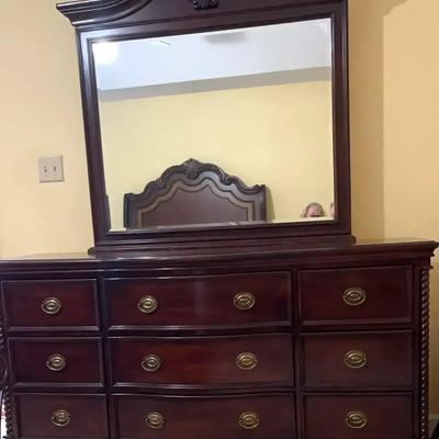 Ornate Wooden Nine-Drawer Dresser With Matching Mirror