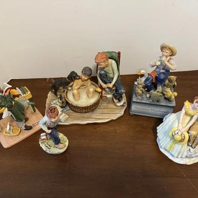 Five vintage porcelain figurines based on illustrations by Norman Rockwell