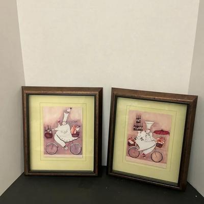 a pair of framed art prints by the Canadian painter Jennifer Garant. 