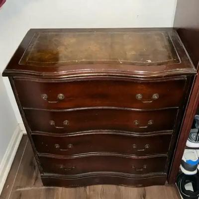 Vintage Mahogany Serpentine-Front Chest Of Drawers With A Leather Top And Brass Pull Handles