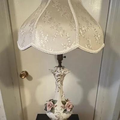 porcelain table lamp with pink roses and an off-white bell shade