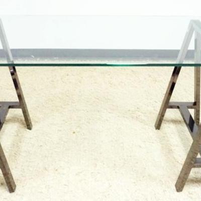 Sale Photo Thumbnail #219: 1210	MODERN GLASS TOP WORK SURFACE WITH 2 SAW HORSE METAL MIRROR FINISH LEGS, APPROXIMATELY 60 IN X 28 IN X 30 IN H
