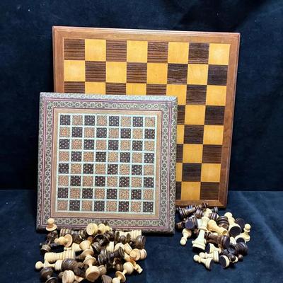 Pair of chessboards with wood pieces