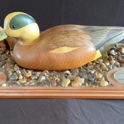 Vintage-style duck carving mounted on a wooden plaque