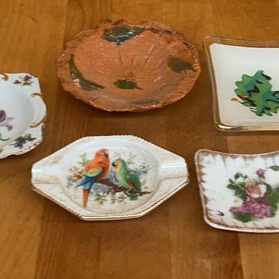 A collection of decorative porcelain dishes, a glass dish, and a studio pottery bowl