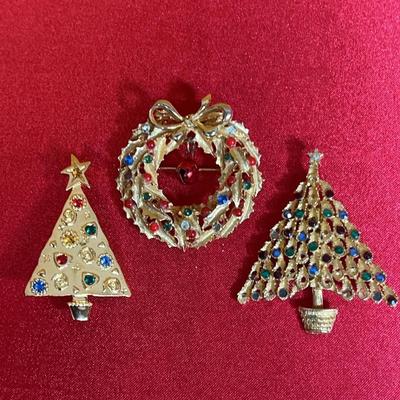 Three vintage gold-tone Christmas brooches with rhinestones