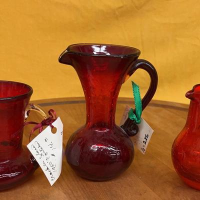 Set of three vintage red crackle glass pitchers or vases