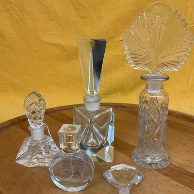 A collection of assorted vintage cut glass and crystal perfume bottles