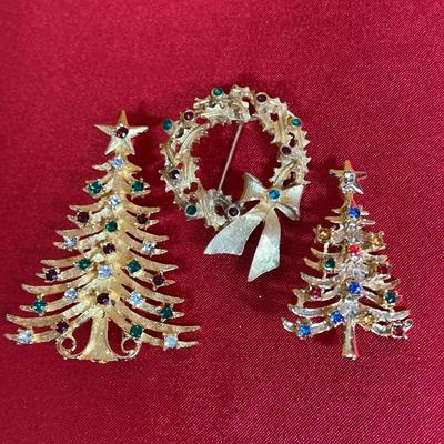 A set of three signed Mylu gold-tone Christmas brooches with rhinestones