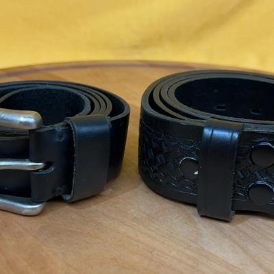 Two size 44 black Levi's leather belts, one plain and one with basket weave embossing