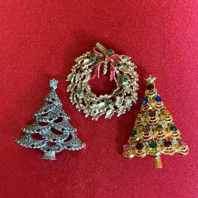 Three vintage Christmas-themed brooches