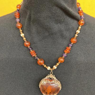 Vintage beaded necklace with amber-like pendant and insect inclusion