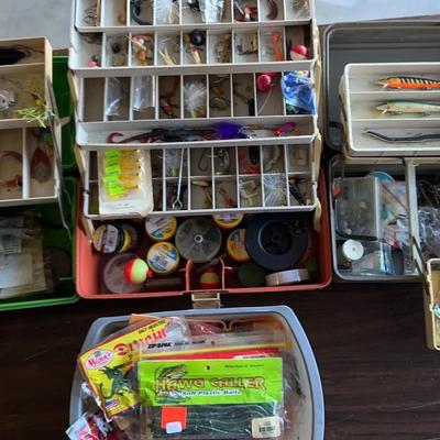 Three Tackle Boxes With Lures And A Container Full Of Plastic Baits