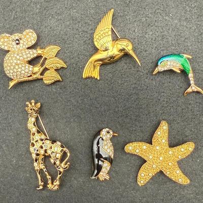 (2) Swarovski Broaches (1) Napier (2) Kreme (1) Casual Corner Brooches