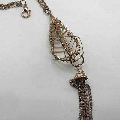 Gold Tone Chain Necklace With A Wire Cage Pendant And A Tassel Charm