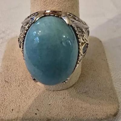 Sterling silver ring with gold-tone accents featuring a large, oval-shaped Gemstone