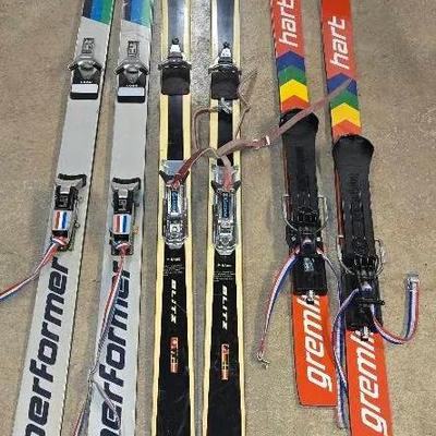 3 Sets Of Skis And 4 Sets Of Poles
