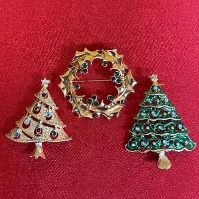Three vintage Christmas-themed metal brooches