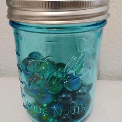A Blue Ball Jar...Missing Half It's Marbles 