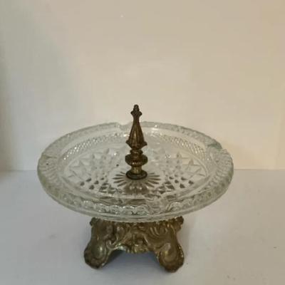 Vintage crystal ashtray with an ornate metal base