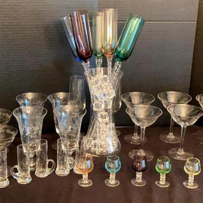 Elegant Glassware Collection With Etched Stems & Colorful Flutes