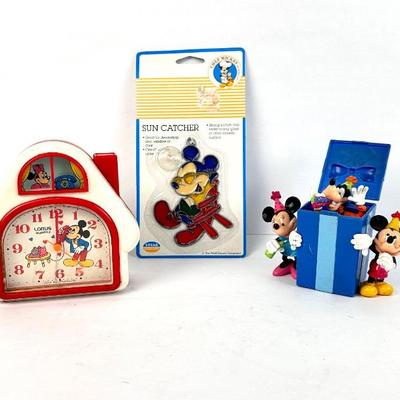Sale Photo Thumbnail #105: Lot #105 Vintage Disney Lot – Mickey Mouse Lorus Clock, Sun Catcher & Birthday Surprise Gift Box Figurine

