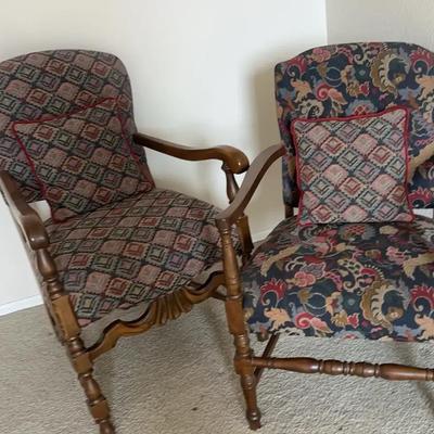 Pair of Upholstered Armchairs with Carved Wood Frames and Complementary Fabric Designs