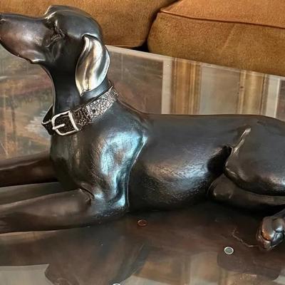 Resting dog statue uttermost
