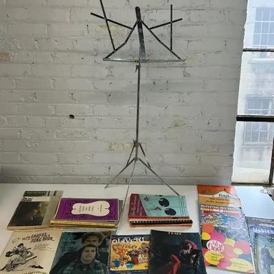Vintage Sheet Music And Song Books For Various Instruments With A Music Stand 