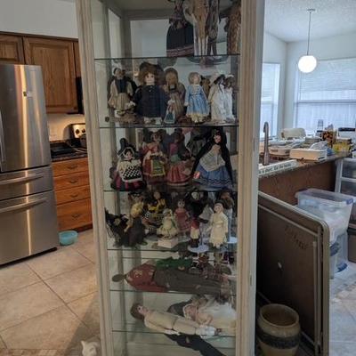Smaller display cabinet with additional dolls. 