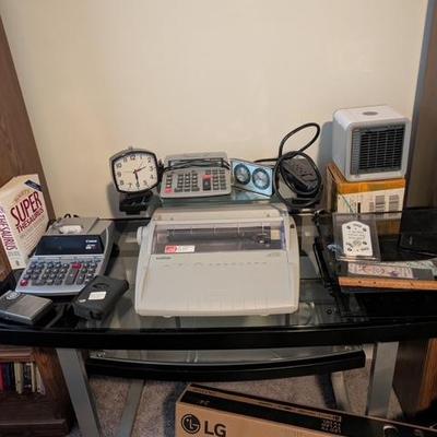 Electric typewriter, full size calculator, glass top office desk, misc