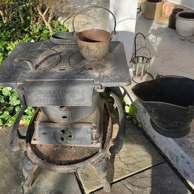 Antique Small Cast Iron Herron Stove On Oval Base - 21x24x22"