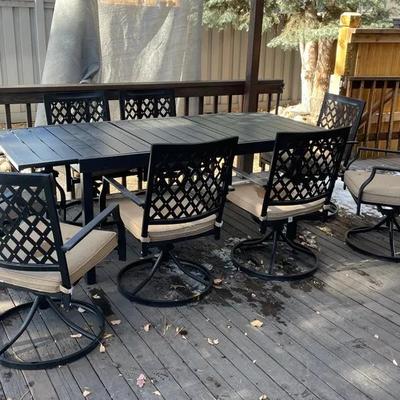 Outdoor Table And 7 Swivel Chairs